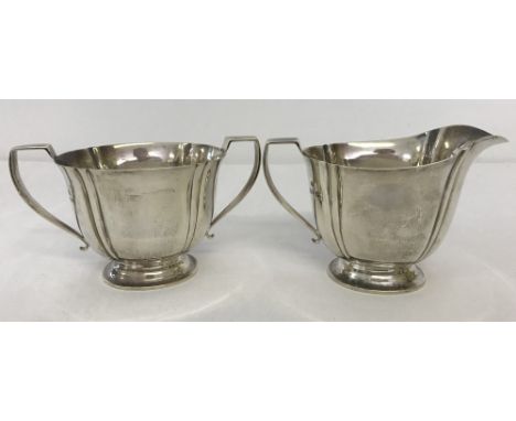 A hallmarked silver 2 handled sugar bowl with matching milk jug. Sugar bowl hallmarked Birmingham 1938, Milk jug hallmarked C