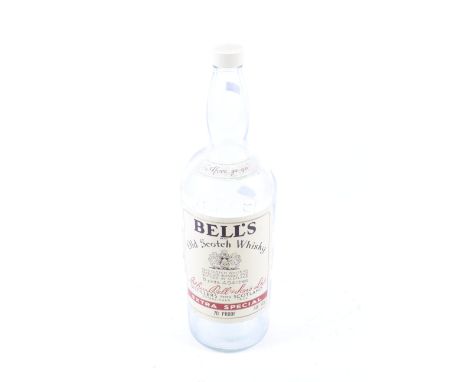 A large empty glass bottle of Bell's Old Scotch Whisky. Marked 'Afore ye go', H51cm