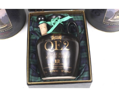 Two Bell's scotch whisky decanters and a bottle of QE2 single malt whisky. The 1991 Bell's 'Year of the Sheep' decanters, 75c