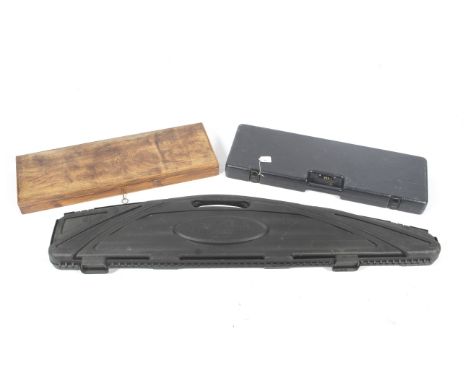 Three gun cases. Comprising a Flambeau example, L135cm, a vintage wooden example, L66cm and a Baretta example, L67cm