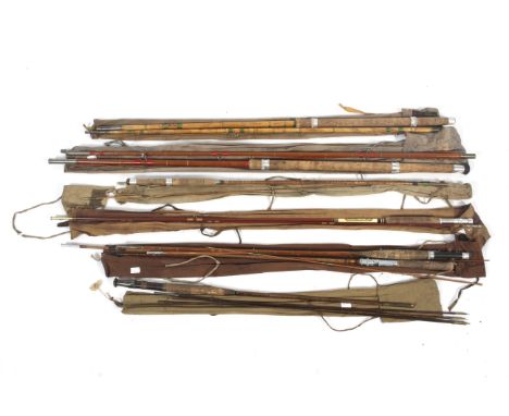 A collection of vintage fishing rods plus a landing net. 