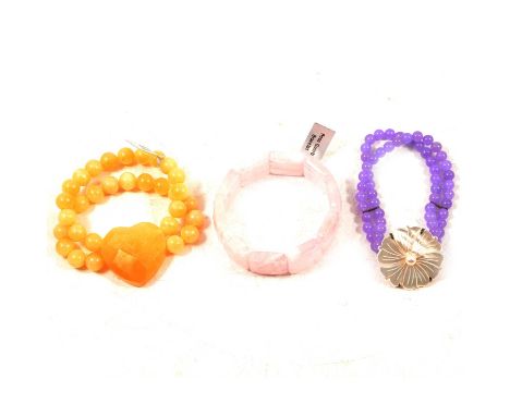 Eleven gemstone bracelets and necklaces, yellow jade, rose quartz, hematite and others, a yellow jade bead bracelet with hear