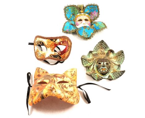 A collection of mostly ceramic wall masks, various sizes and designs, some with material surrounds.Qty: 1 box
