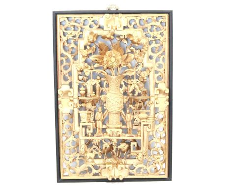 A Japanese ornately carved and gilded framed panel, central urn with flowers, various animals and figures on an open pierced 