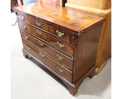 A largely George III figured walnut and banded fold-over top desk, fitted four long graduated drawers, on bracket feet, 38" w