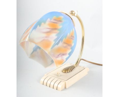 An Art Deco Bakelite and brass table lamp with blue and orange glass shade