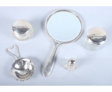 A quantity of assorted silver including a tea strainer, two dressing table jars with lids, an engine turned mirror, etc