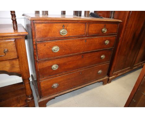 A 19th century oak chest of two short and three long drawers with oval brass handles, on bracket supports, 42" wide