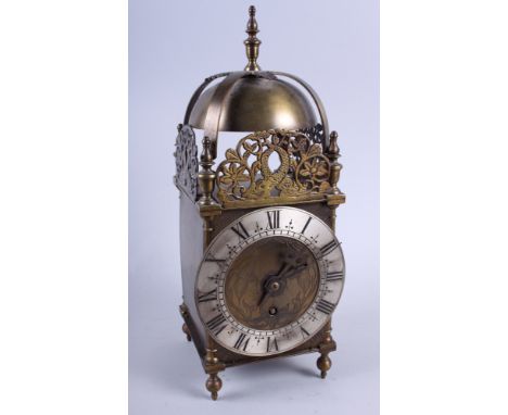 A brass lantern clock of 17th century design with silvered chapter ring, 16" high