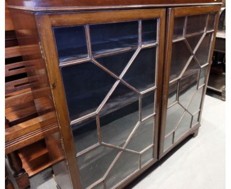 A mahogany bookcase with dentil cornice and astragal moulded glazed doors, on bracket feet, 48" wide
