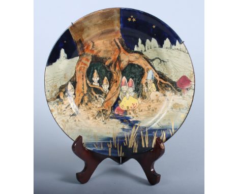 A Royal Dolton "Gnome" pattern series ware plate, designed by Charles Noke, gnomes at the base of a tree trunk with gilt deco