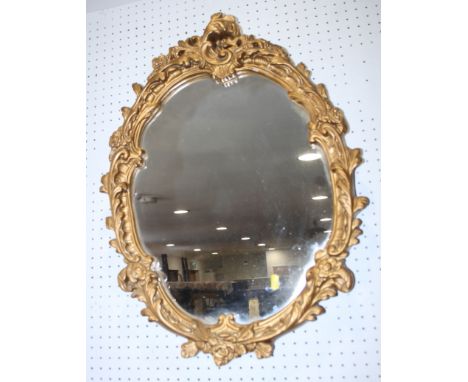 A wall mirror, 37" x 21" overall, in gilt frame