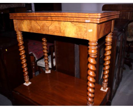 A figured walnut quarter veneered fold-over top card table, on four barley twist supports, 34" wide