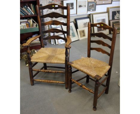 A 19th century ash ladder back elbow chair with rush envelope seat and a companion standard chair