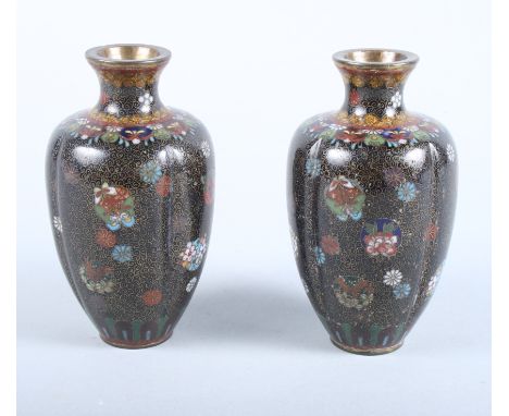 A pair of early 20th century Japanese cloisonne baluster vases, decorated panels of flowers on a black scale ground, 4 1/2" h