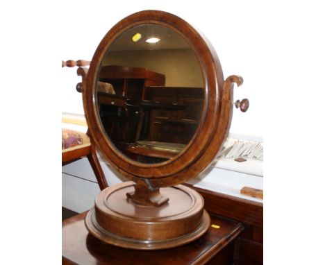 A Victorian mahogany circular swivel dressing table mirror, on circular base