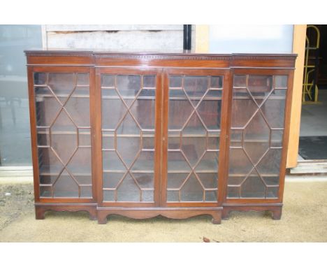A late 19th century mahogany breakfront bookcase with dentil cornice over four astragal glazed panel doors, on bracket feet, 