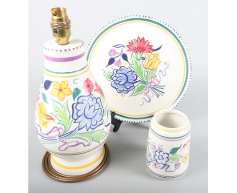 A Poole pottery lamp base with floral decoration, 10" high, a similar vase and a similar plate