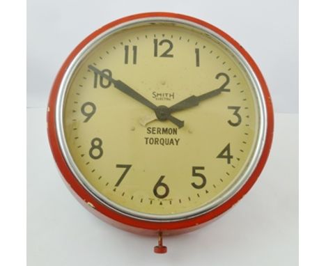 A "SMITHS" ELECTRIC WALL CLOCK, the Bakelite case painted red, the dial with Arabic numerals, inscribed "Smith Electric" and 