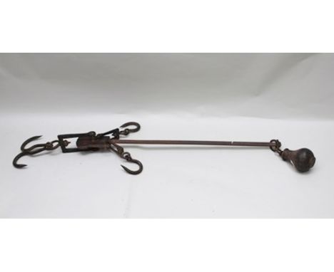 A 19TH CENTURY IRON BEAM SCALE with sliding balance weight on calibrated arm, mounted with various suspension hooks, beam 93c