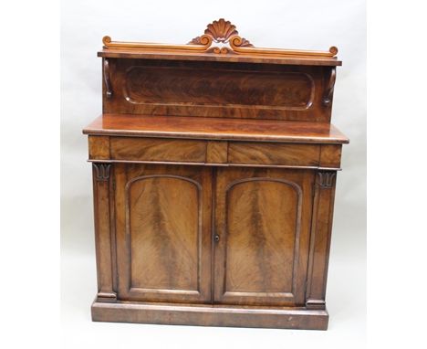 A REGENCY MAHOGANY CHIFFONIER having shelf and gallery back with carved shell motif, fitted two frieze drawers and twin panel