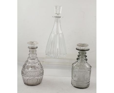 TWO EARLY 19TH CENTURY CUT GLASS DECANTERS, with mushroom stoppers, together with a larger fluted 20th century DECANTER and s
