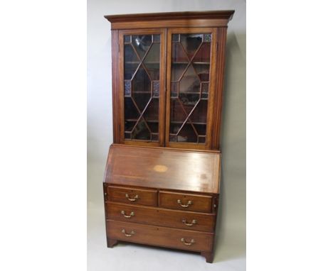 A GEORGE III MAHOGANY BUREAU BOOKCASE the top fitted with two astragal glazed doors, the fall front inset patera, opening to 