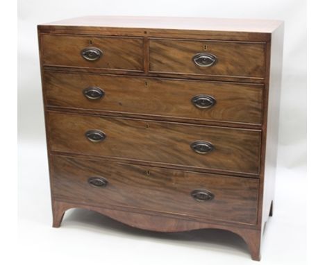GEORGE III MAHOGANY CHEST of two short over three long graduated drawers, oval brass stamped back handles, raised on outswept