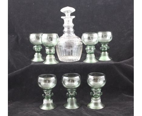 A SET OF SEVEN GREEN TINTED GLASS RUMMERS, with applied prunus stems, the bowls engraved with a seated hound crest and the Ba