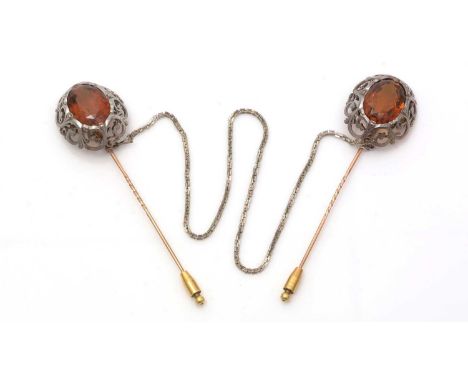 A pair of Victorian citrine cloak pins, each pin set with an oval facet-cut citrine measuring approximately 25 x 18 x 11.5mm,