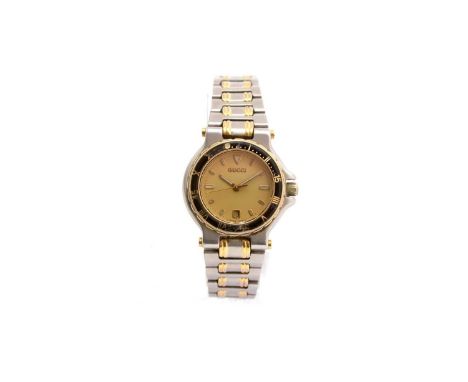 Gucci: a steel cased quartz wristwatch, ref 9700 1, serial no.0002735, circa 1995, the black baton dial with date aperture, f