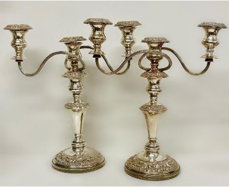 A pair of substantial three light silver on copper candlesticks