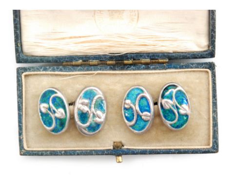 A pair of hallmarked silver oval cufflinks with blue green enamel decoration, three panels stamped Cymric and dated Birmingha