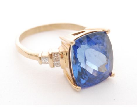 A modern 18ct simulated tanzanite and diamond ring, cushioned emerald cut simulated tanzanite flanked by three square cut dia