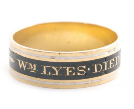 A 19th Century 22ct memorial ring with Wm Lyes Died 14th Jan 1820 Aged 89 picked out in gold to a black band with white ename