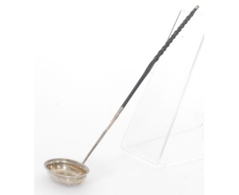 A George IV hallmarked silver toddy ladle, plain oval bowl below twisted whale bone handle, length 38cm, London 1821, George 