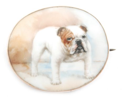An early 20th Century oval brooch, the 9ct rose gold frame mounted with a painted ceramic plaque depicting a standing bulldog