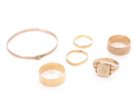 An 18ct wedding ring, weight 7.4g, two 22ct wedding rings, weight 3.9g, two 9ct rings and a child's bangle, weight 15.7g, A/F