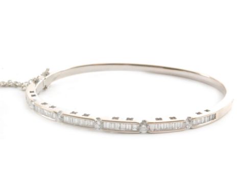 A contemporary 18ct white gold diamond hinged bangle comprising six panels of baguette cut diamonds spaced by five collar set