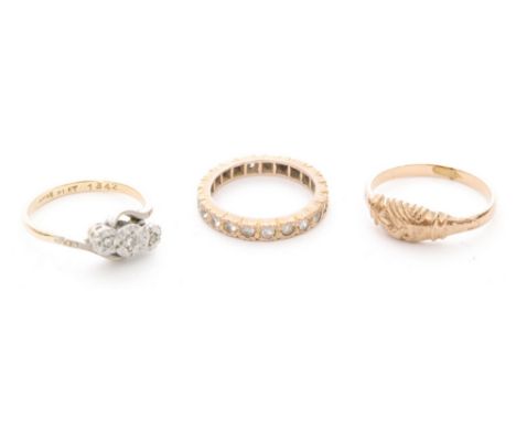 An 18ct and platinum illusion set diamond three stone ring with two other 9ct rings. (3)