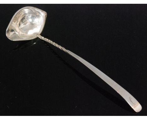 A George IV hallmarked silver cream ladle with elliptical shaped bowl below part twisted stem and flattened terminal, length 