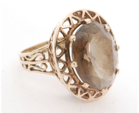 A 1970s single stone smoky quartz ring, claw set stones with pierced head and shoulders, Birmingham 1977, ring size P. 