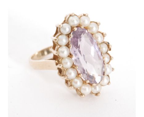 A 9ct hallmarked amethyst and seed pearl ring, central amethyst within seed pearl set border, ring size L. 