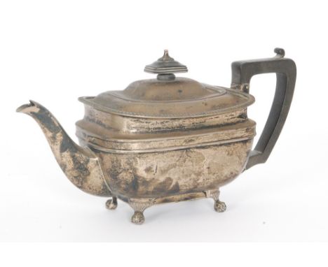 A hallmarked silver boat shaped tea pot raised on four paw feet, weight 24ox, Sheffield 1921, Harrison Brothers &amp; Howson.