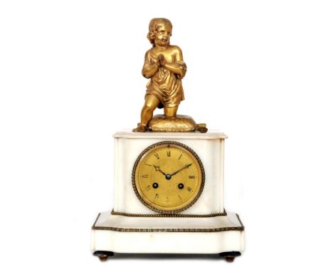 A 19th Century white marble cased mantle clock with eight day striking movement mounted with a figure of a boy praying kneeli