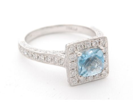 A platinum aquamarine and diamond ring, cushioned square aquamarine within a diamond surround and diamond set shoulders, ring