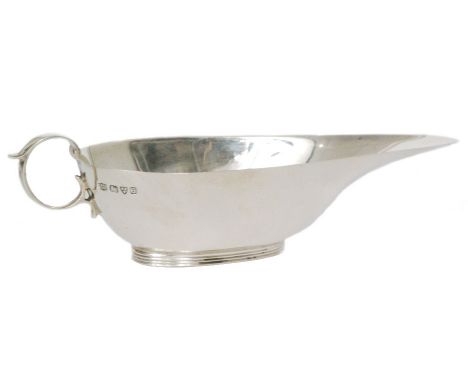 An Art Deco hallmarked silver mint sauce boat of plain elongated form, terminating in ring handle and raised on a reeded ring