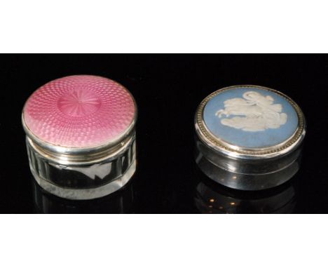 A hallmarked silver and clear glass rouge pot with pink enamel decoration to cover, with a silver and Wedgwood panel example,