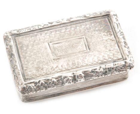A George IV hallmarked silver rectangular vinaigrette with engine turned decoration within raised foliate borders, opening to