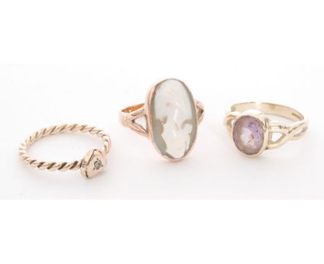 Three 9ct rings to include a rope twist example set with a single diamond, a single stone amethyst and a cameo example, vario